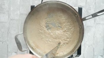 chicken fried steak frying in a skillet