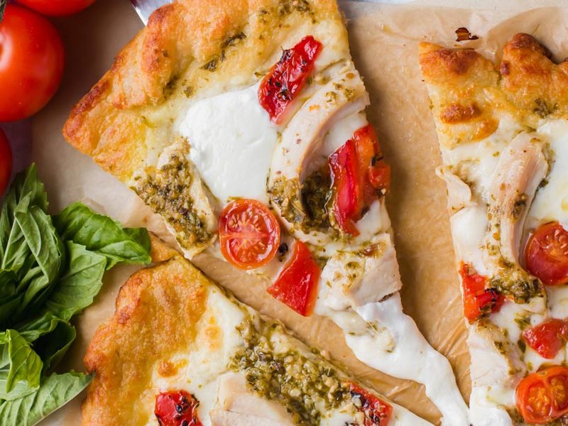 cheese pull with keto chicken pesto pizza