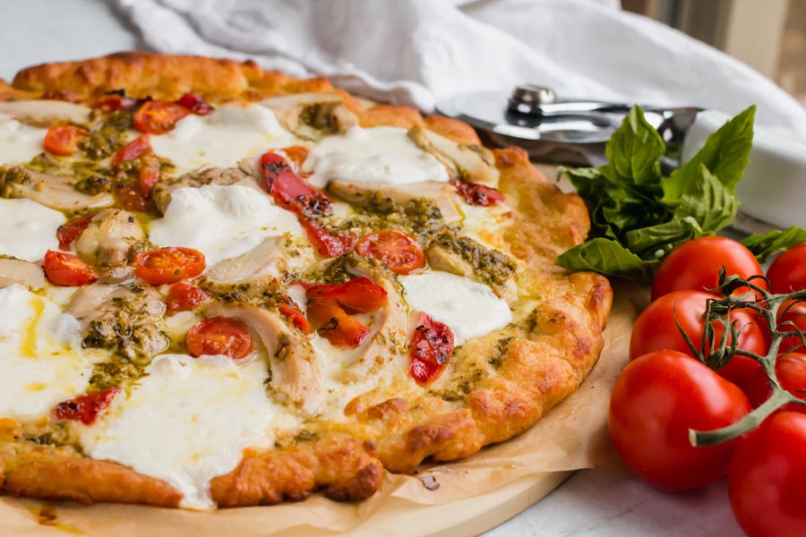 whole pizza with chicken pesto and tomatoes