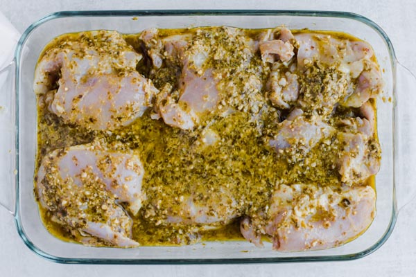 chicken thighs covered in pesto sauce