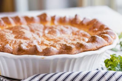 a whole baked pie in a white pie plate