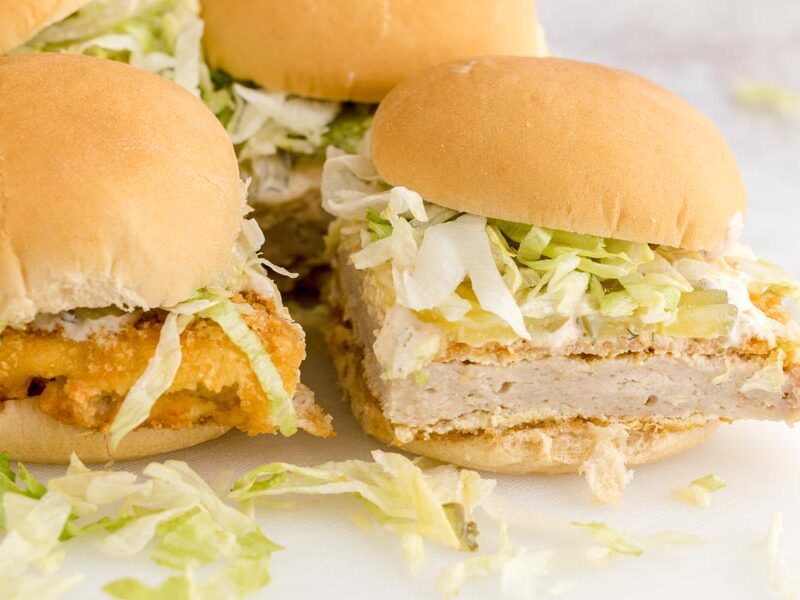 Keto McChicken sandwiches showing the thick ground chicken patty, crispy coating, shredded lettuce, pickles, and creamy sauce.