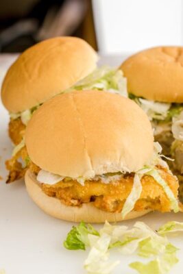Homemade keto McChicken sandwiches made with crispy chicken patties, shredded lettuce, pickles, and creamy sauce on low-carb buns.