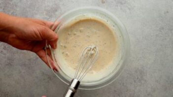 Creamy spicy pickle ranch sauce being whisked together for the keto McChicken sandwiches.