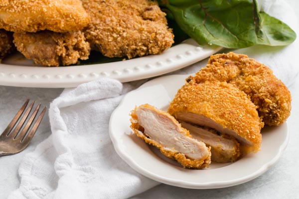 sliced keto chicken schnitzel on a plate