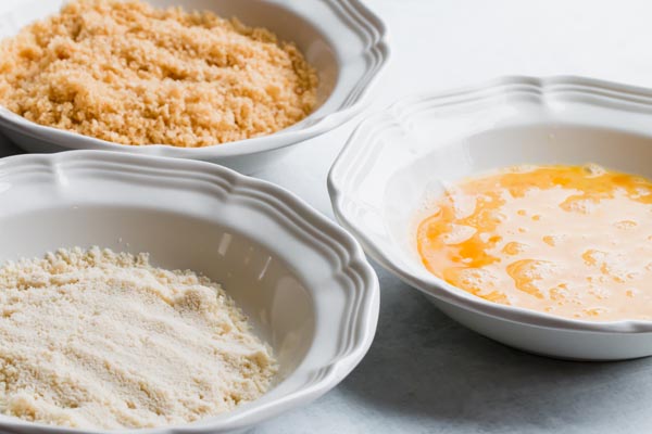 three dipping bowls of breading for chicken