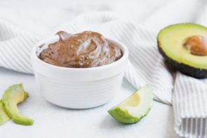 creamy chocolate pudding next to sliced avocados