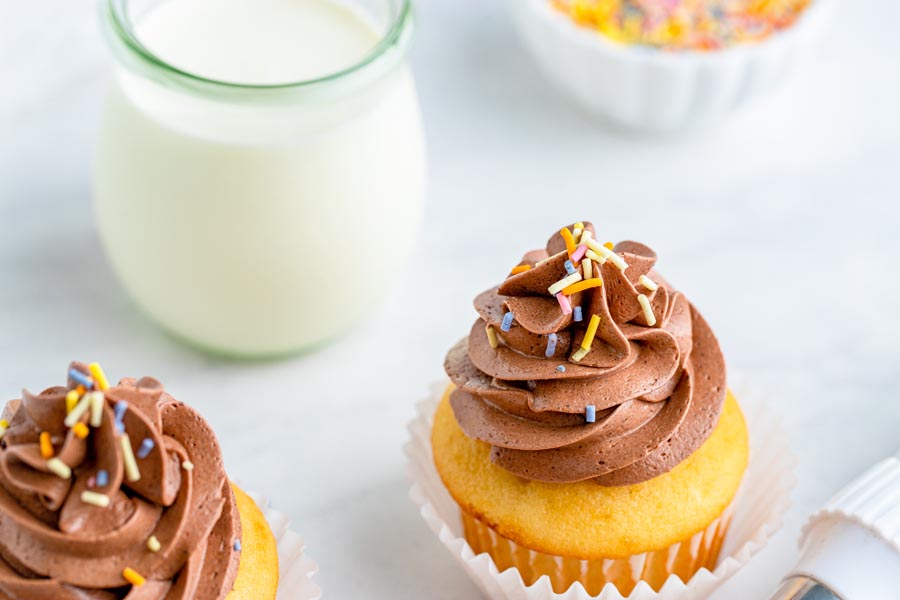 a glass of milk with keto cupcakes