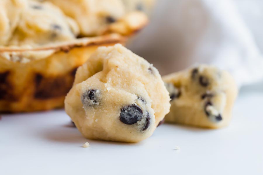 a closeup on a cookie dough bite with chocolate chips inside