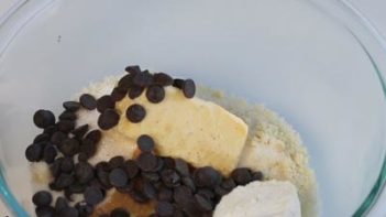 ingredients for cookies in a bowl with chocolate chips