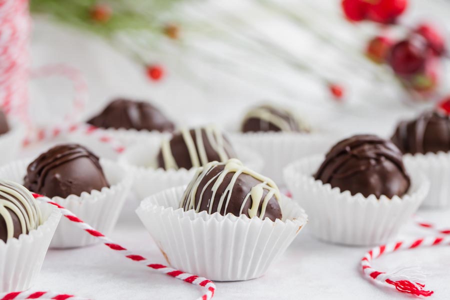 white chocolate topped chocolate truffles with garland in the background