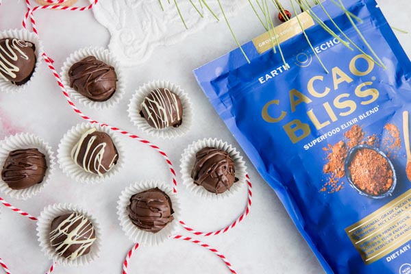 chocolate truffles next to a bag of cacao bliss