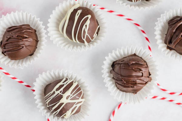 four keto truffles sitting in mini cupcake liners