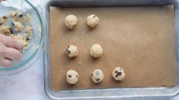rolled balls of cookie dough on a tray