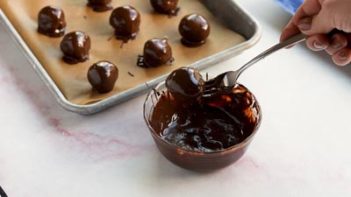 dipping truffles in melted chocolate with a fork