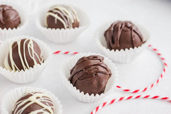 white chocolate and milk chocolate covered truffles with red and white rope around