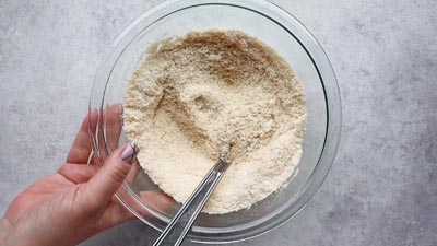 Almond flour mixture in a bowl with a whisk