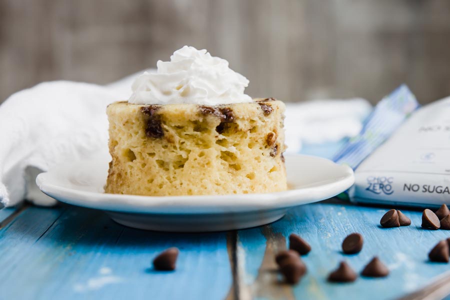 small cake on a blue table with chocolate chips