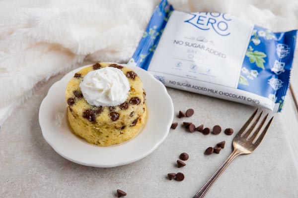 keto chocolate chip mug cake next to a bag of sugar-free chocolate chips