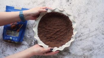 chocolate pie crust in a white pie plate