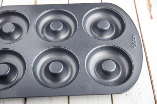 metal donut baking pan on a wooden counter