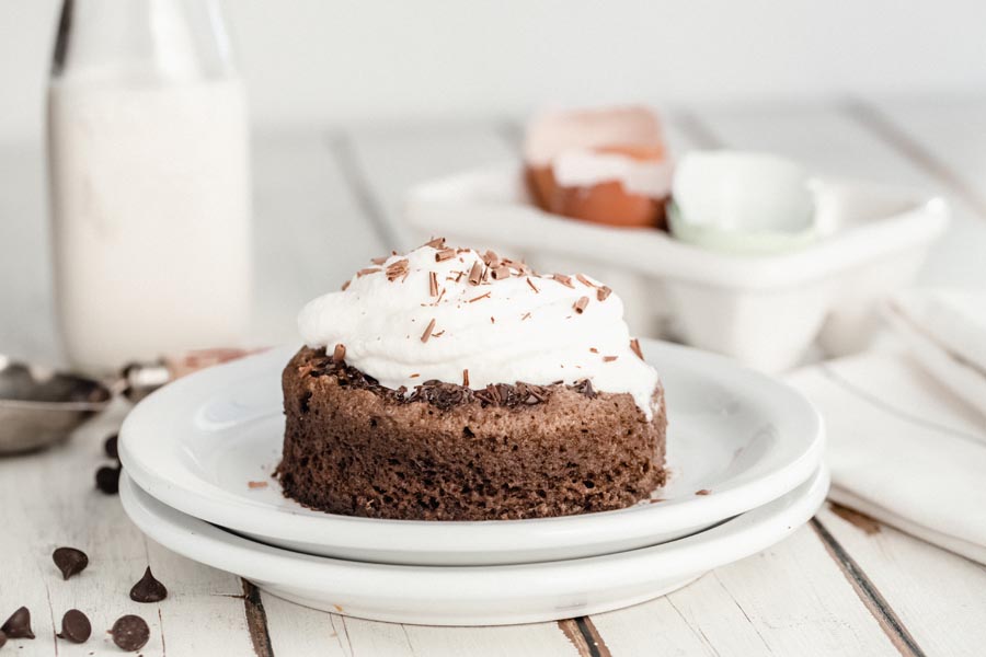 whipped cream and chocolate shavings on a chocolate cake