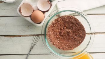 dry ingredients in a glass bowl with eggs near