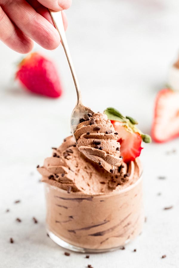 holding a spoon with chocolate mousse on it