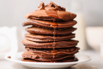 thick stack of chocolate pancakes with