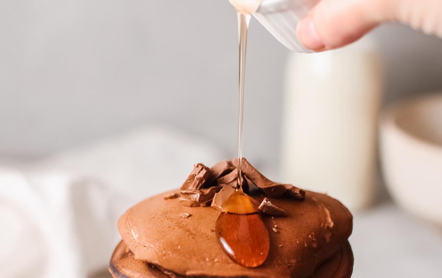 sugar-free syrup dripping from chocolate pancakes