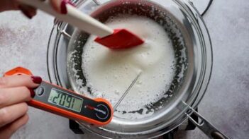 Mixing white whites and in a double boiler with a spatula and using an instant read thermometer to measure temperature to 160 degrees F.