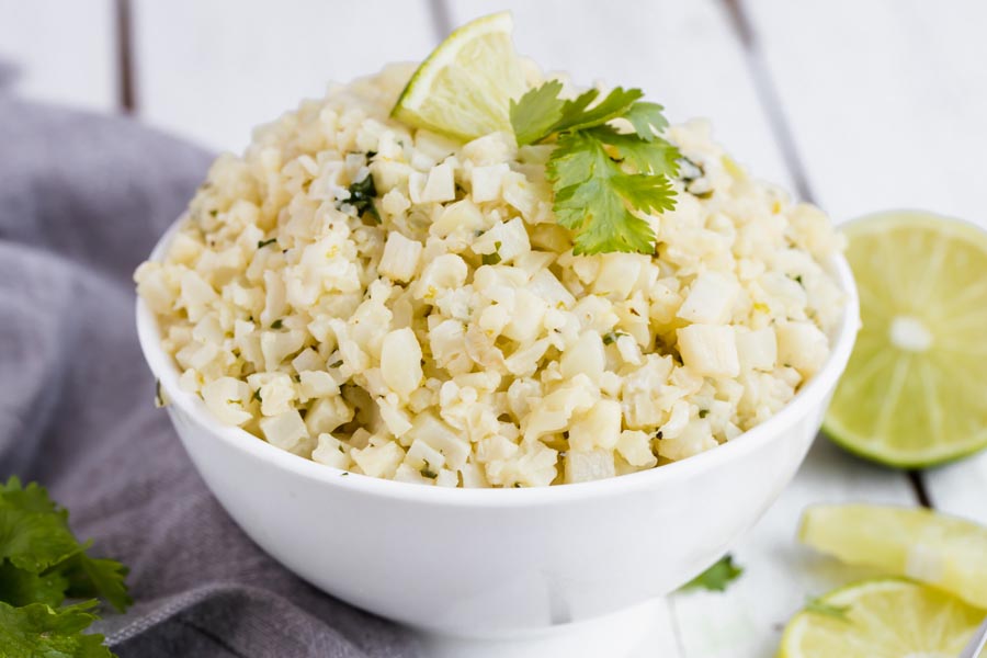 big bowl of cilantro lime cauliflower rice with cilantro scattered on top