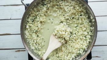 a wooden spatula scooping out cauliflower rice