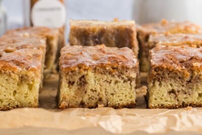 Slices of cinnamon coffee cake on parchment paper.