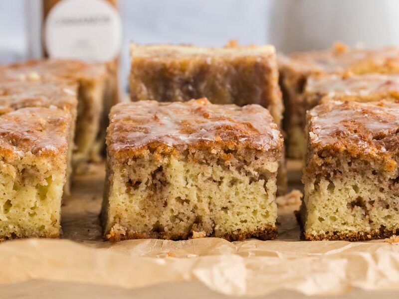 Slices of cinnamon coffee cake on parchment paper.
