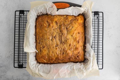 A baked cake in a square baking dish.