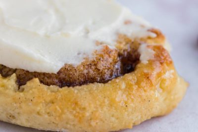 gooey warm cinnamon rolls topped with cream cheese frosting