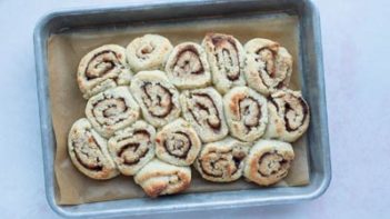 baked unfrosted cinnamon buns on a tray