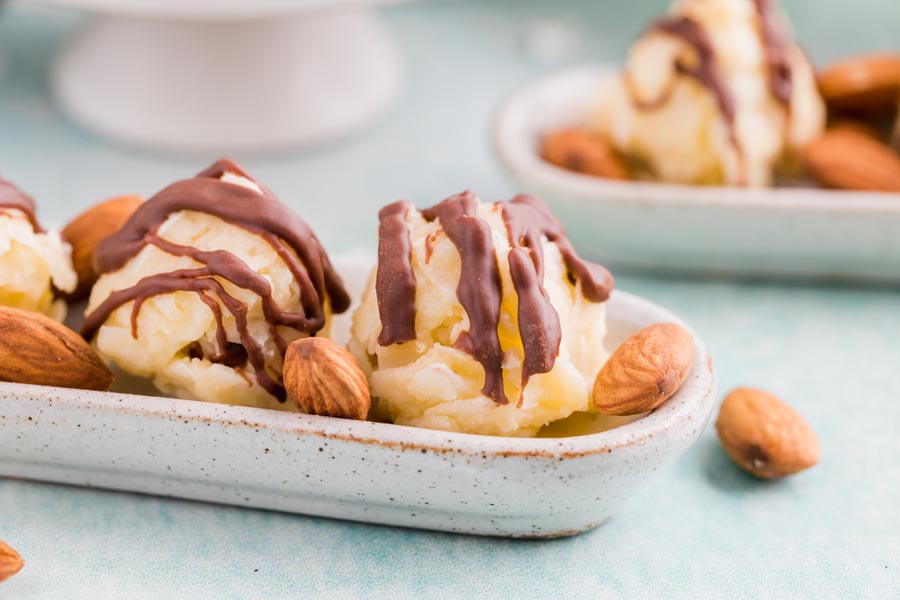 small keto candies coated with chocolate are next to almonds