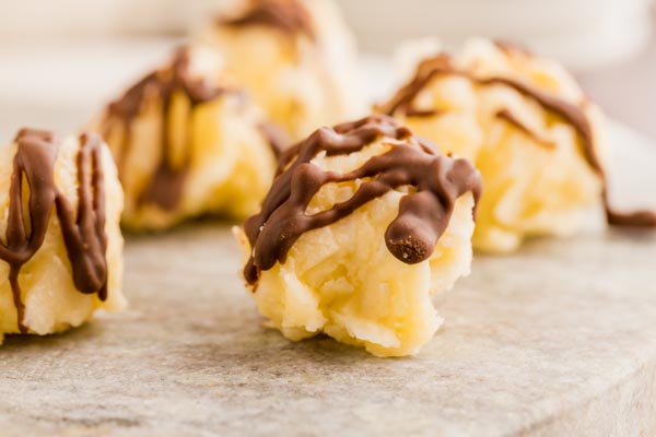 chocolate covered coconut candies on a marble plate