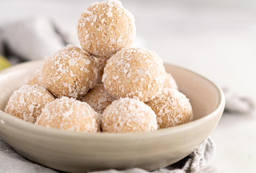 a tower of keto balls colored white and covered in coconut flakes