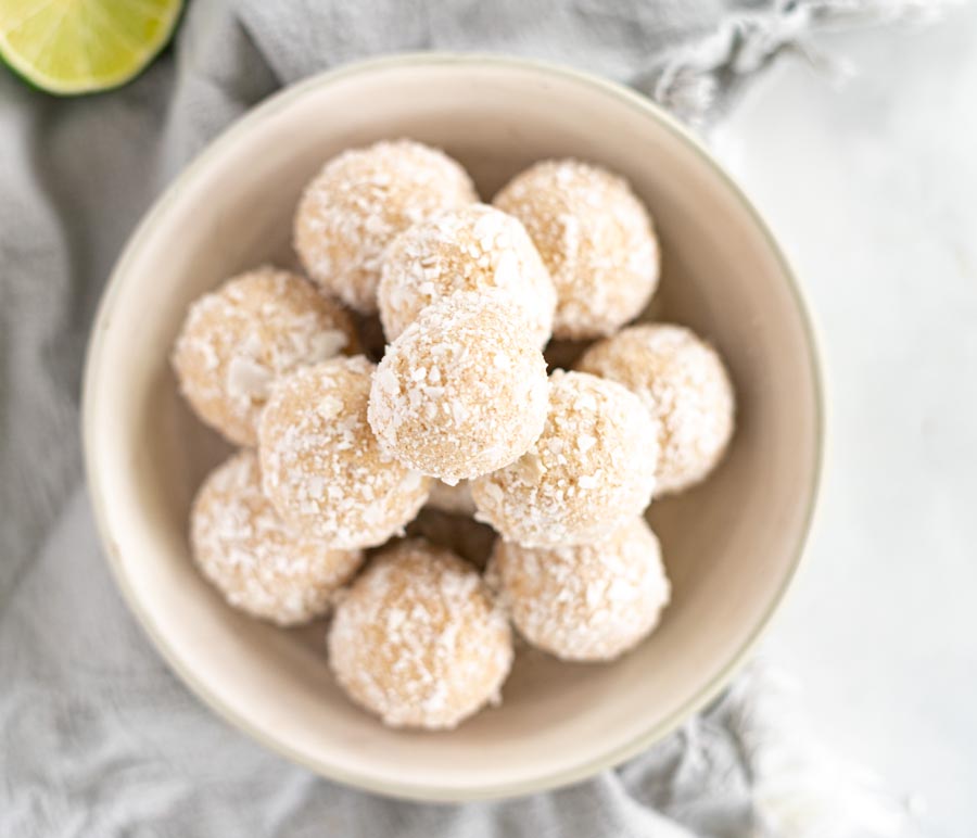 looking down on a bunch of coconut covered bites in a bowl