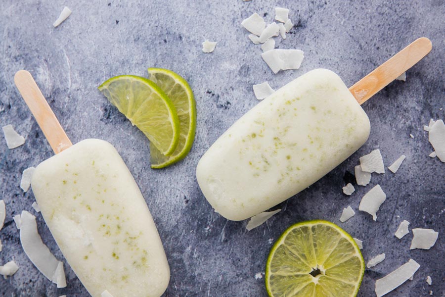 two frozen white popsicles with a lime slice