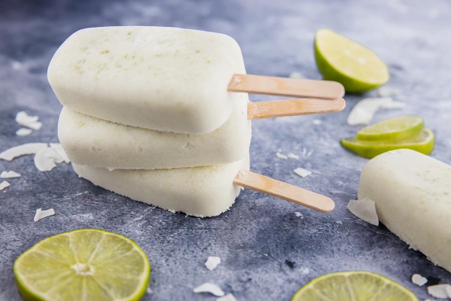 a small stack of coconut popsicles with lots of lime slices