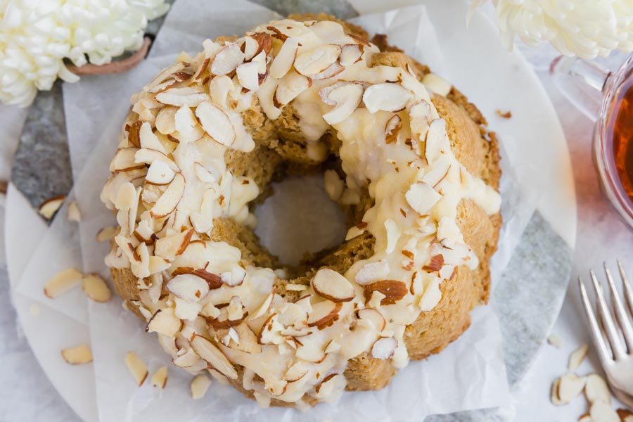 looking down on an almond and icing topped bundt cake