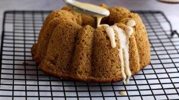 drizzling icing over the top of a cooked bundt cake