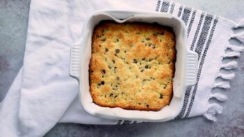 Freshly baked pan of cookie bars on a towel.