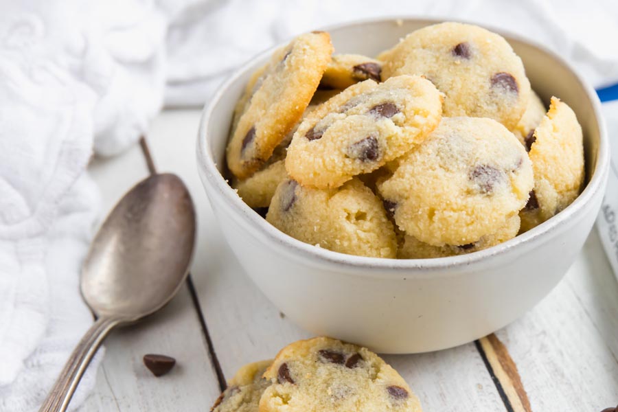 mini cookies in a cereal bowl with chocolate chips scattered