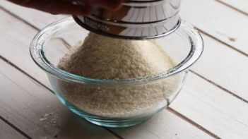 sifting dry ingredients with a metal sifter