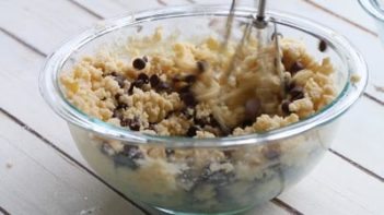 using an electric mixer to mix in chocolate chips